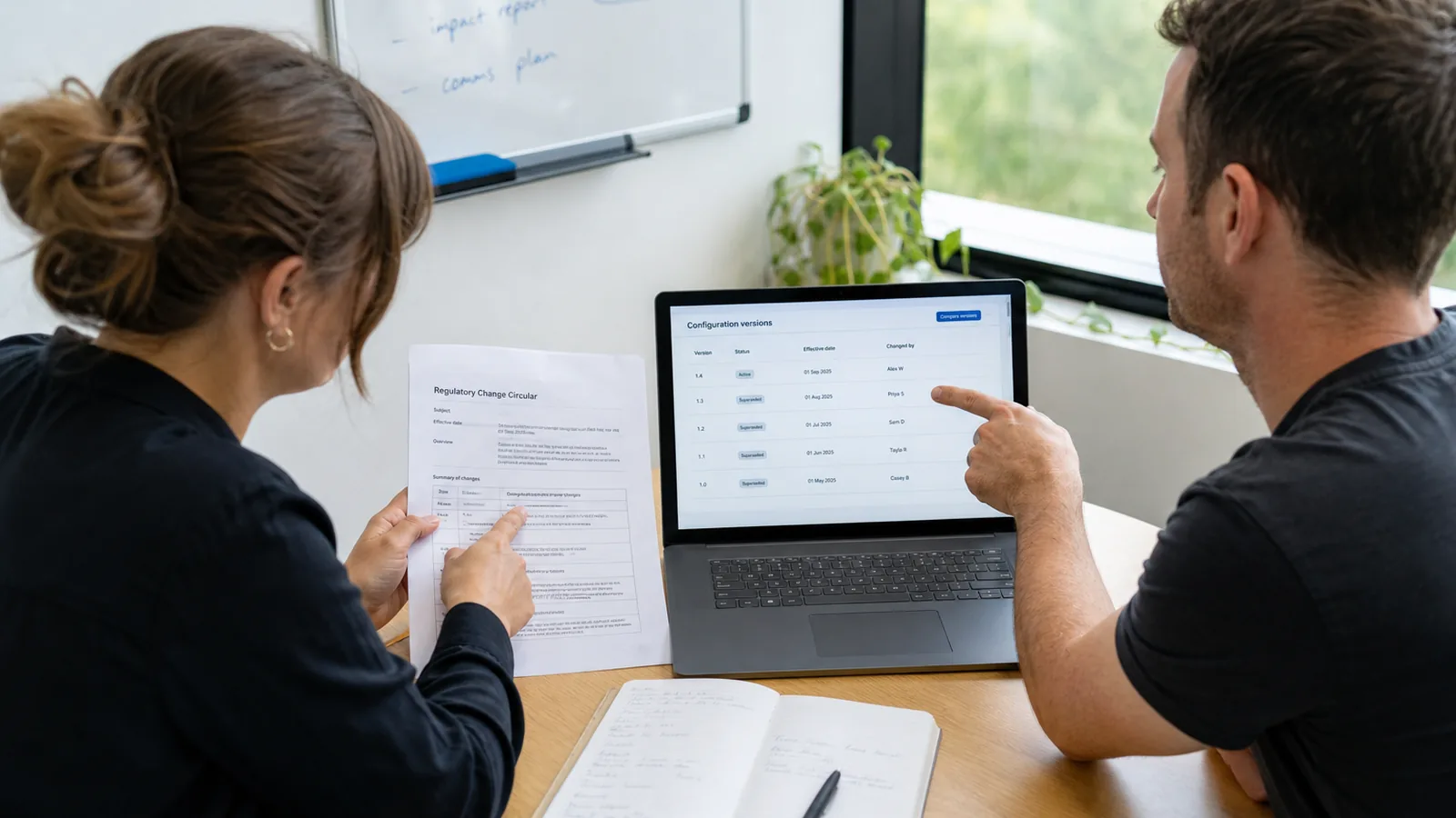 Product team comparing a printed regulatory change note with versioned configuration on a laptop